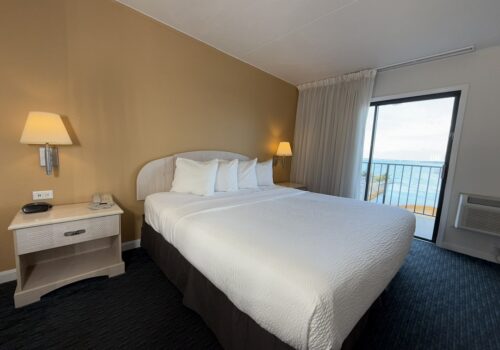 bayfront-king-2025 one king size bed and a beautiful ocean view outside the window